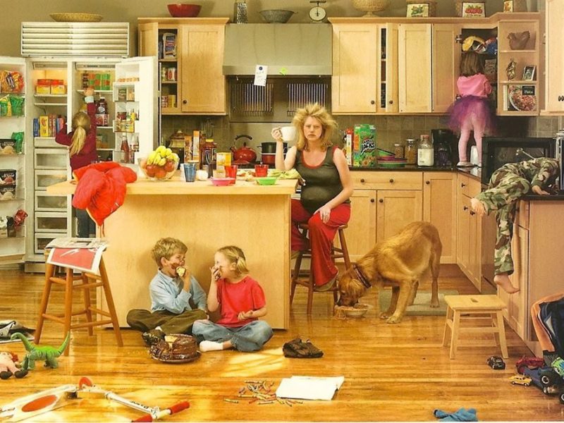 mother in a messy household with children and a dog